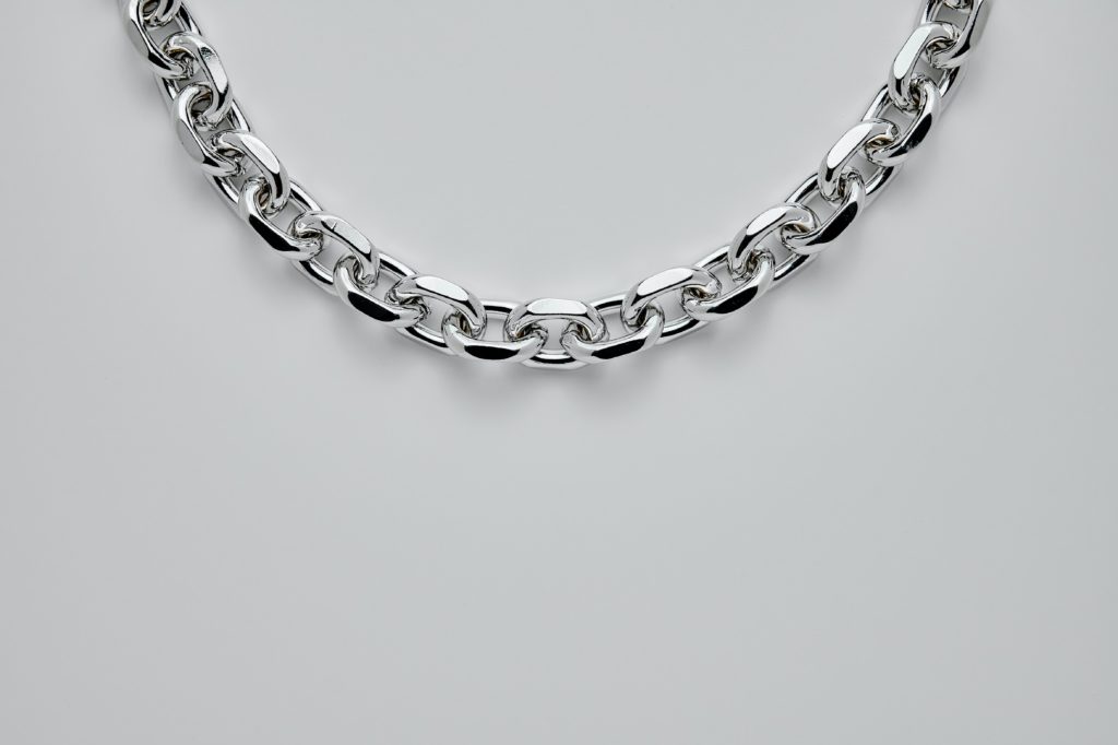 silver necklace on white background